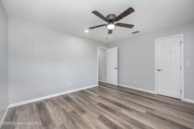 1521 Baker St NE, Palm Bay, FL 32907 - unfurnished bedroom featuring baseboards, wood finished floors, recessed lighting, and a ceiling fan