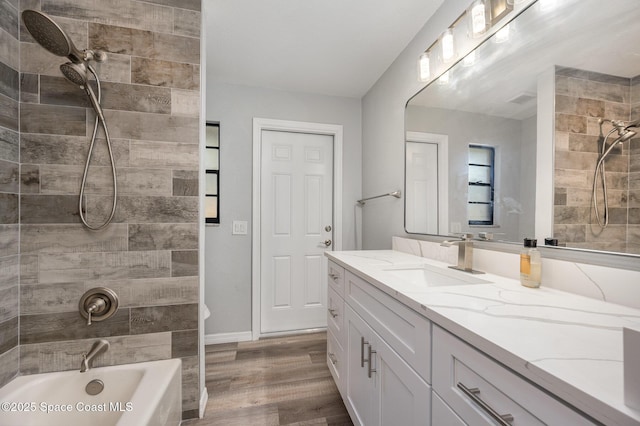 1521 Baker St NE, Palm Bay, FL 32907 - bathroom with vanity, bathtub / shower combination, wood finished floors, and baseboards