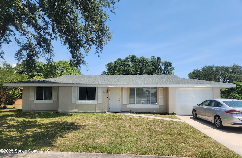 991 Gatewood Ct NE, Palm Bay, FL 32905 - ranch-style house with a garage, a front yard, concrete driveway, and a shingled roof