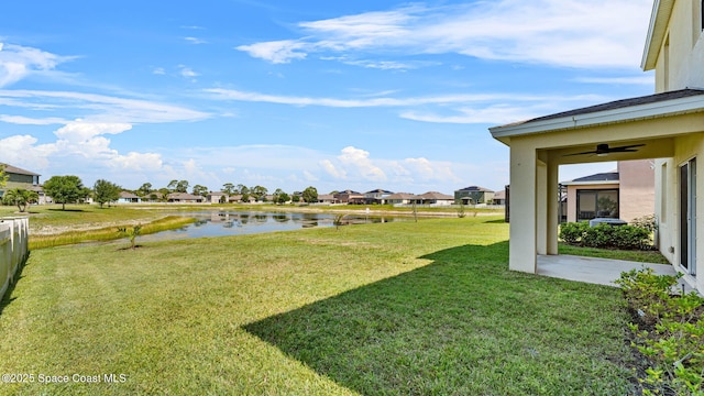 422 Moray Dr SW, Palm Bay, FL 32908 - view of grassy yard with a water view, a ceiling fan, and a residential view