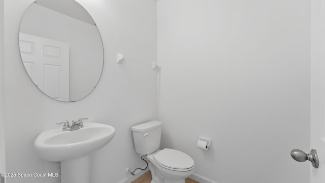 422 Moray Dr SW, Palm Bay, FL 32908 - bathroom with toilet, baseboards, and a sink
