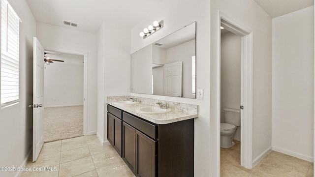 422 Moray Dr SW, Palm Bay, FL 32908 - full bathroom with double vanity, toilet, tile patterned floors, and plenty of natural light