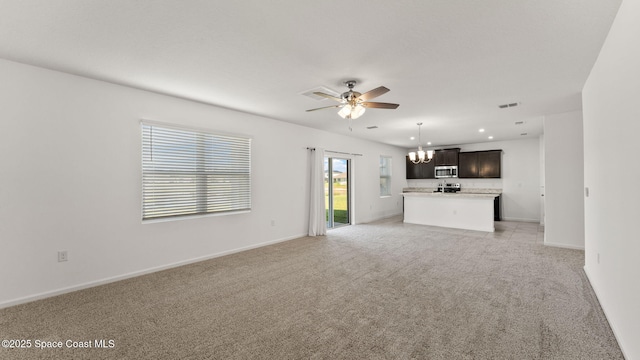 422 Moray Dr SW, Palm Bay, FL 32908 - unfurnished living room featuring a chandelier, ceiling fan, light carpet, baseboards, and recessed lighting