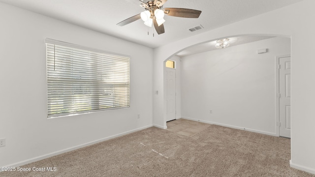 422 Moray Dr SW, Palm Bay, FL 32908 - carpeted spare room featuring arched walkways, ceiling fan, and baseboards