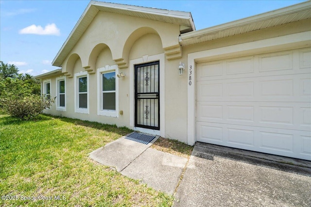 3380 Toledo Ave, Palm Bay, FL 32908 - doorway to property featuring stucco siding, a yard, and a garage