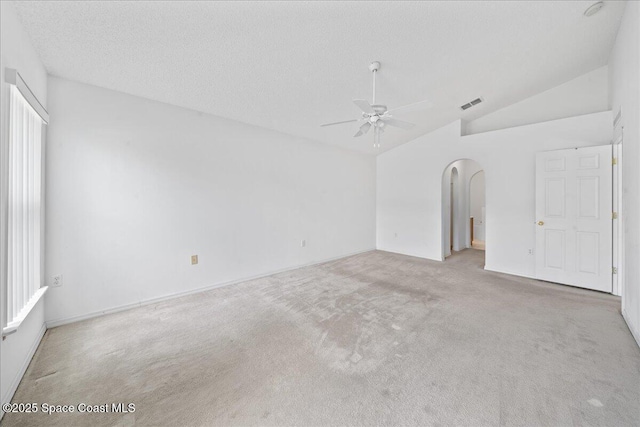 3380 Toledo Ave, Palm Bay, FL 32908 - carpeted spare room featuring vaulted ceiling, ceiling fan, arched walkways, and baseboards