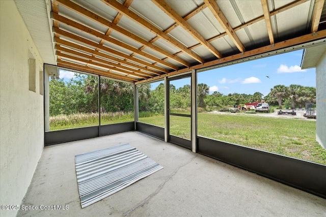 3380 Toledo Ave, Palm Bay, FL 32908 - unfurnished sunroom with view of wooded area