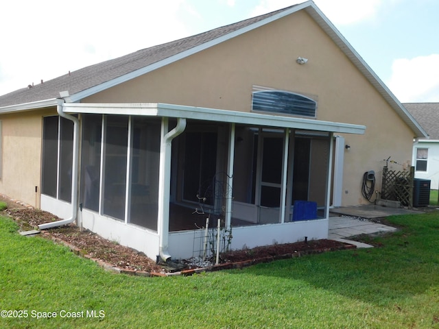1076 Pine Creek Cir NE, Palm Bay, FL 32905 - rear view of property with a sunroom, stucco siding, a yard, and central AC unit