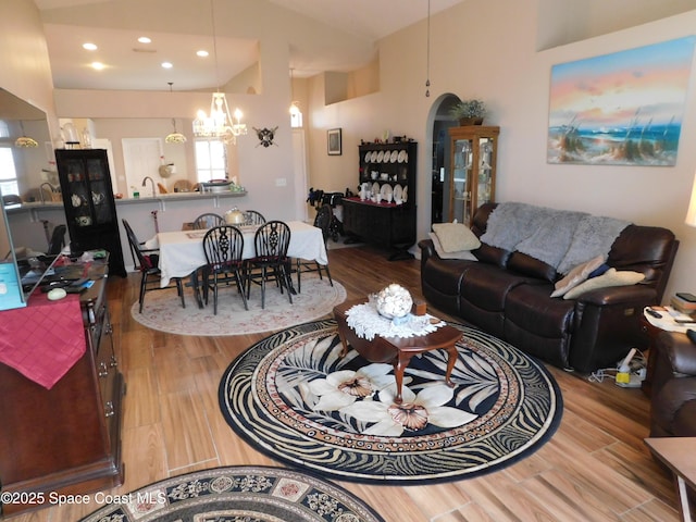 1076 Pine Creek Cir NE, Palm Bay, FL 32905 - living room featuring wood finished floors, a chandelier, recessed lighting, and arched walkways