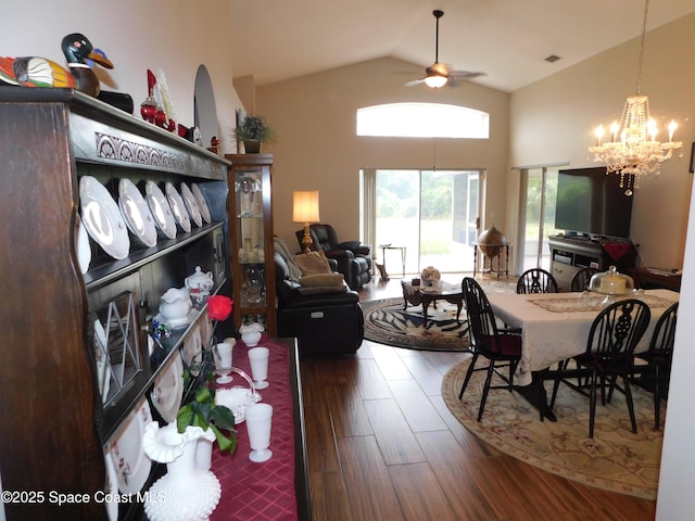 1076 Pine Creek Cir NE, Palm Bay, FL 32905 - dining space featuring ceiling fan, wood finished floors, a chandelier, and high vaulted ceiling