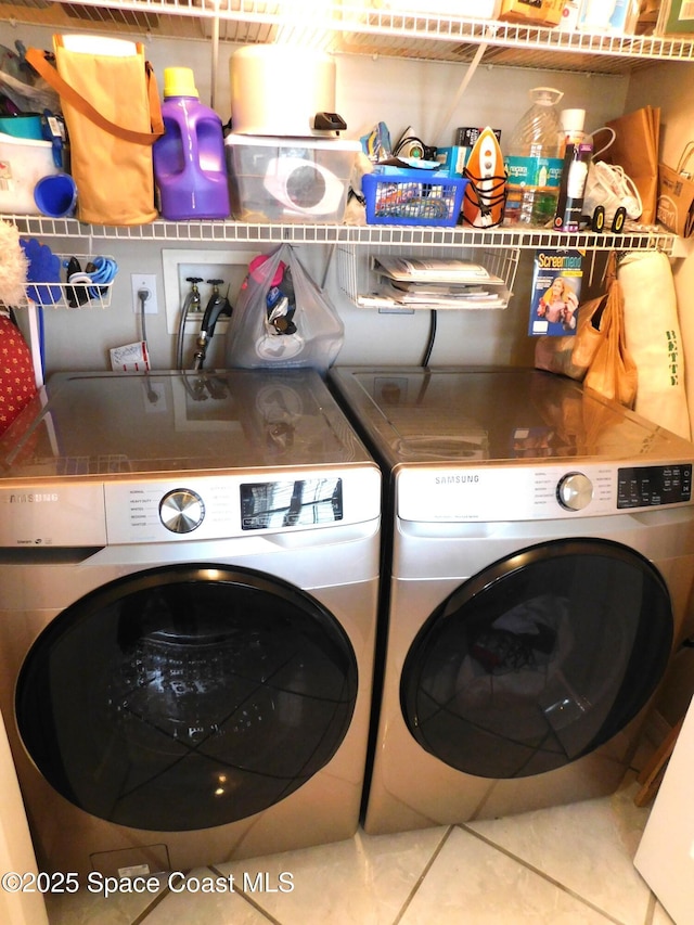 1076 Pine Creek Cir NE, Palm Bay, FL 32905 - washroom featuring washing machine and dryer and tile patterned floors