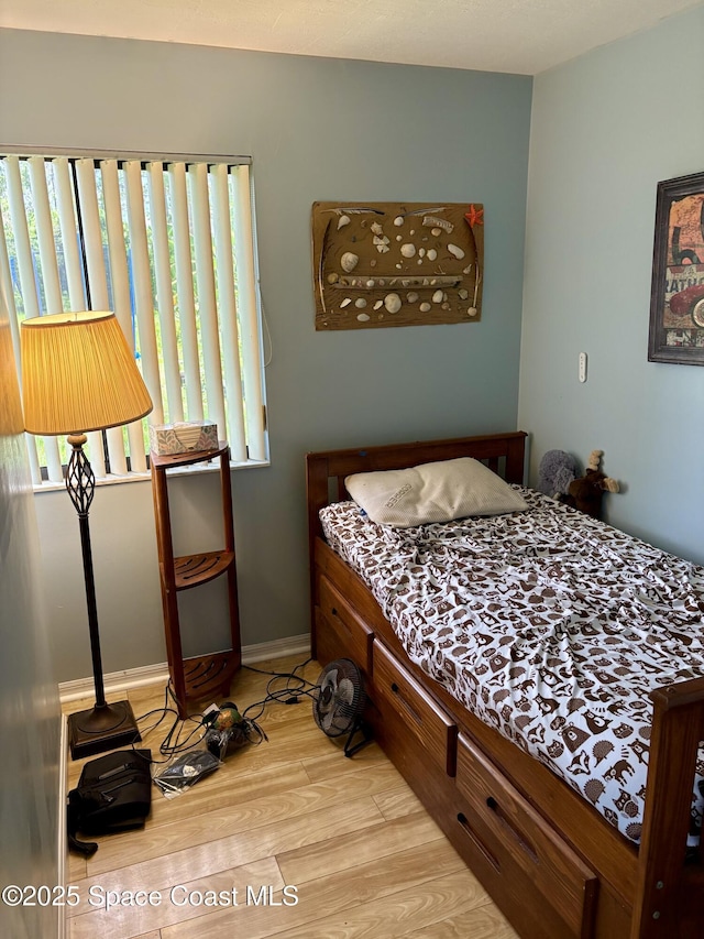 322 Ixora Ave NW, Palm Bay, FL 32907 - bedroom featuring light wood finished floors and baseboards