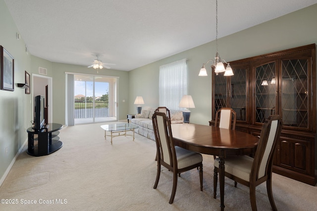 6848 Toland Dr Unit 208, Melbourne, FL 32940 - dining area with carpet floors, a chandelier, a ceiling fan, and baseboards