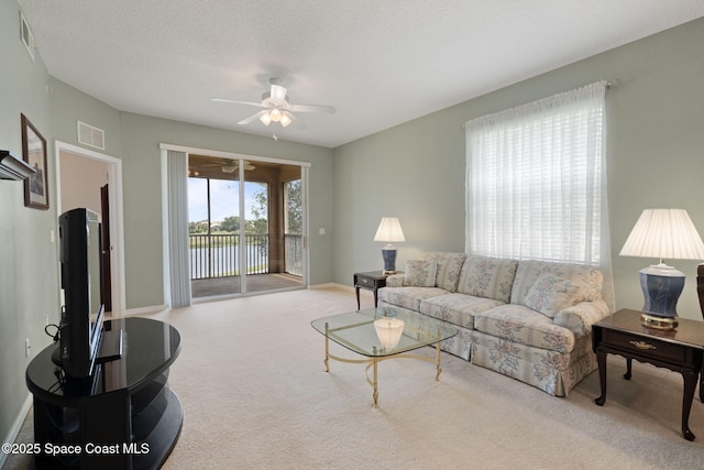 6848 Toland Dr Unit 208, Melbourne, FL 32940 - living area featuring ceiling fan, carpet, and baseboards