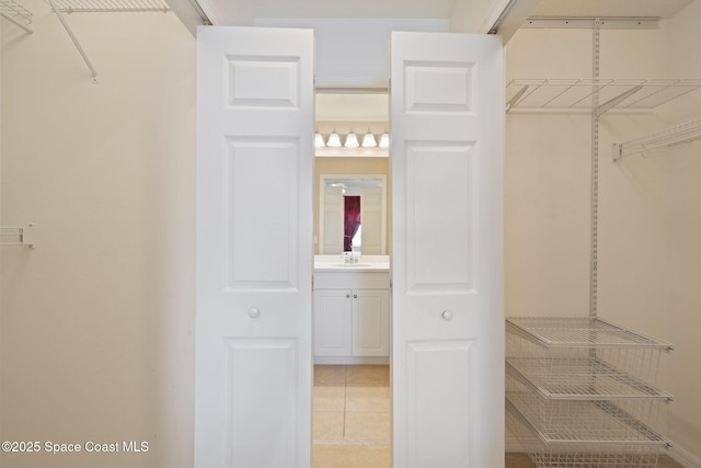 6848 Toland Dr Unit 208, Melbourne, FL 32940 - walk in closet featuring light tile patterned floors and a sink