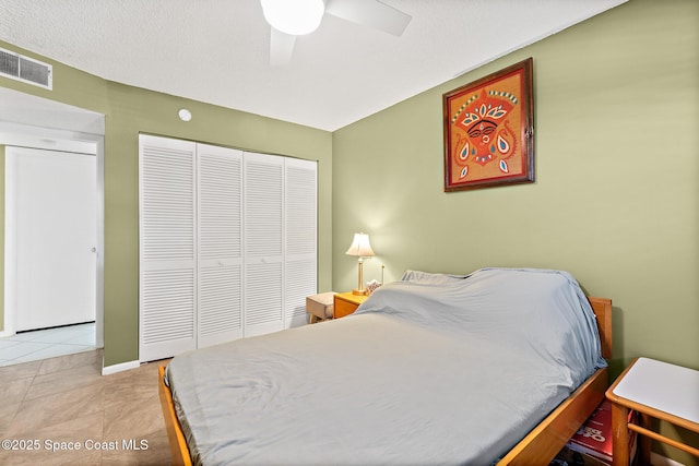1700 N Atlantic Ave Unit 133, Cocoa Beach, FL 32931 - bedroom featuring a closet, tile patterned floors, and ceiling fan