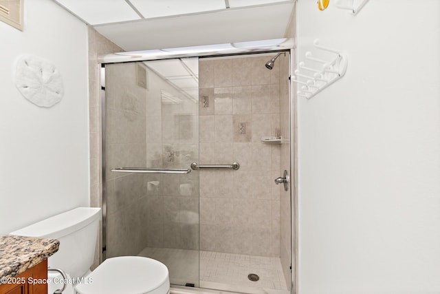 1700 N Atlantic Ave Unit 133, Cocoa Beach, FL 32931 - bathroom featuring toilet, vanity, and a stall shower