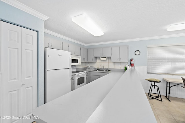 1700 N Atlantic Ave Unit 133, Cocoa Beach, FL 32931 - kitchen featuring white appliances, gray cabinets, light countertops, a textured ceiling, and crown molding