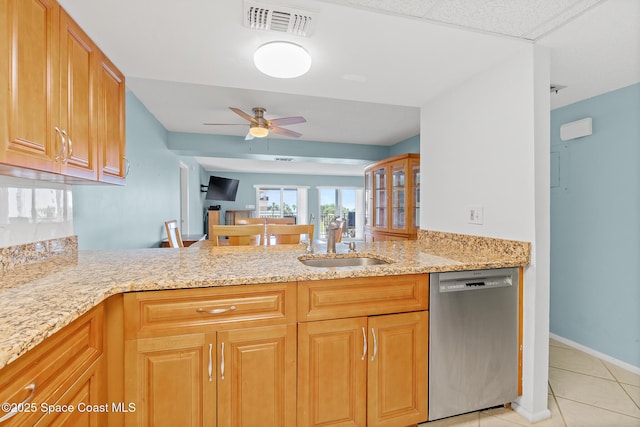 1700 N Atlantic Ave Unit 133, Cocoa Beach, FL 32931 - kitchen with dishwasher, light tile patterned floors, light stone counters, a ceiling fan, and a peninsula