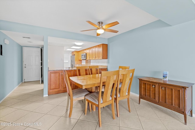 1700 N Atlantic Ave Unit 133, Cocoa Beach, FL 32931 - dining space with ceiling fan and light tile patterned floors