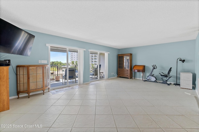 1700 N Atlantic Ave Unit 133, Cocoa Beach, FL 32931 - living room featuring baseboards and a textured ceiling