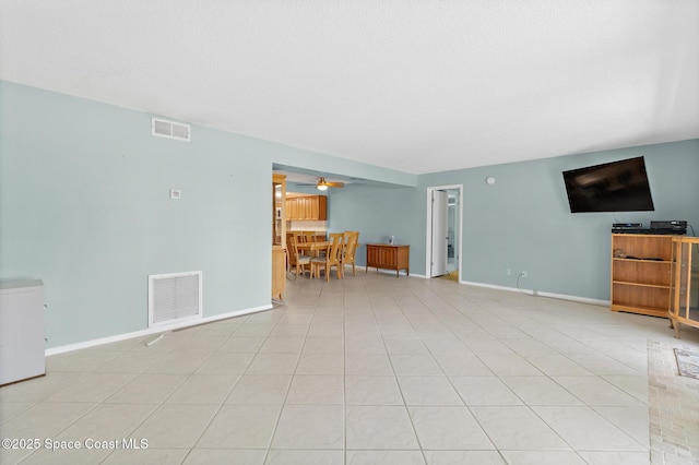 1700 N Atlantic Ave Unit 133, Cocoa Beach, FL 32931 - unfurnished living room featuring ceiling fan and baseboards