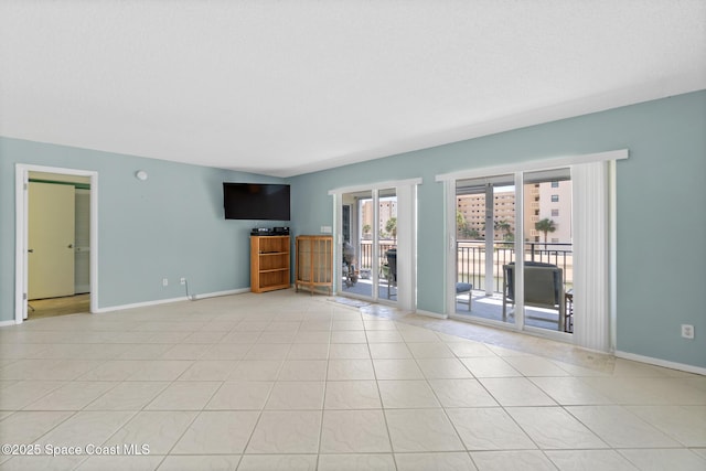 1700 N Atlantic Ave Unit 133, Cocoa Beach, FL 32931 - unfurnished living room featuring baseboards and light tile patterned floors