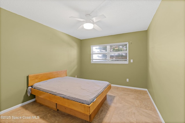 1700 N Atlantic Ave Unit 133, Cocoa Beach, FL 32931 - bedroom featuring a textured ceiling and a ceiling fan