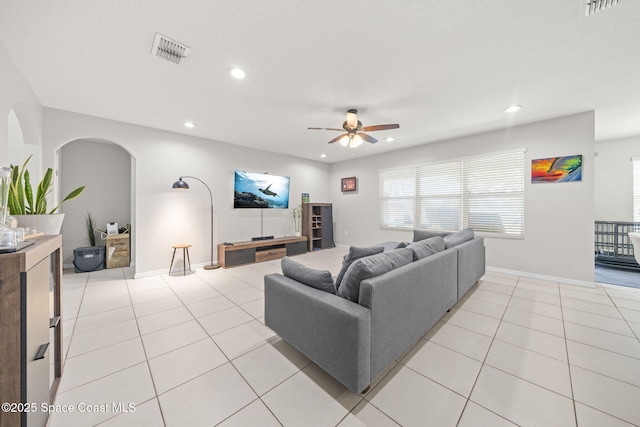 3779 Bishop Landing Way, Orlando, FL 32824 - living area featuring a ceiling fan, arched walkways, recessed lighting, light tile patterned floors, and baseboards