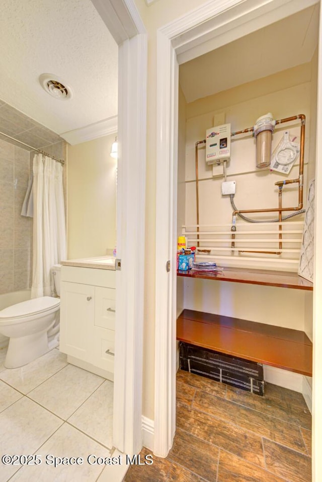 350 Taylor Ave Unit 2B3, Cape Canaveral, FL 32920 - bathroom featuring tiled shower, toilet, vanity, wood finished floors, and baseboards