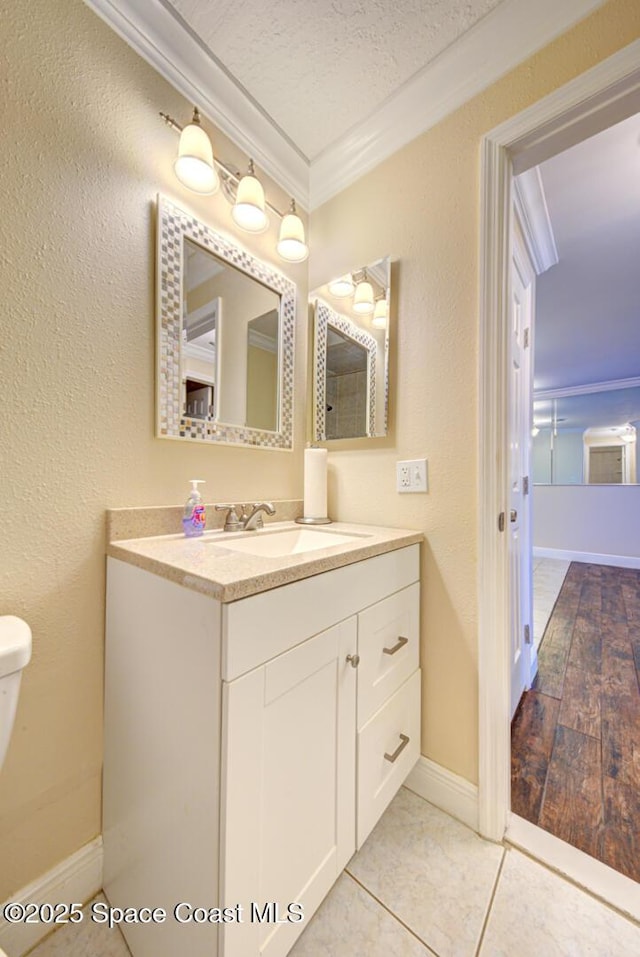 350 Taylor Ave Unit 2B3, Cape Canaveral, FL 32920 - bathroom with crown molding, vanity, toilet, baseboards, and a textured ceiling