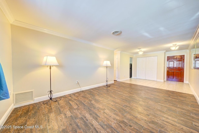 350 Taylor Ave Unit 2B3, Cape Canaveral, FL 32920 - empty room featuring ornamental molding, wood finished floors, and baseboards