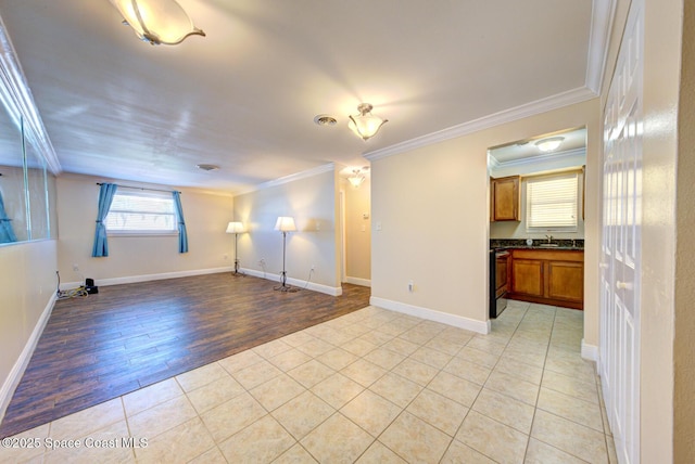 350 Taylor Ave Unit 2B3, Cape Canaveral, FL 32920 - unfurnished living room with ornamental molding, a sink, light tile patterned floors, and baseboards