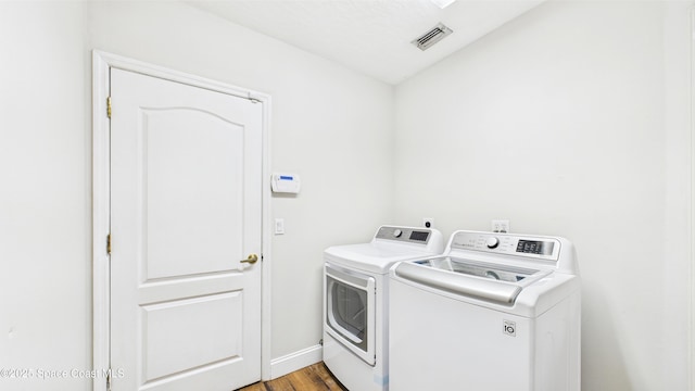 3266 Helmsdale Ct, Melbourne, FL 32940 - laundry area with separate washer and dryer, light wood-style flooring, and baseboards