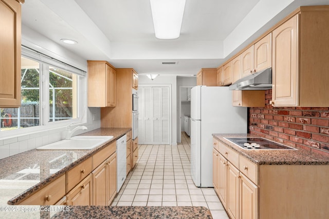 345 Dorset Dr, Cocoa Beach, FL 32931 - kitchen with under cabinet range hood, light brown cabinetry, a sink, white appliances, and recessed lighting