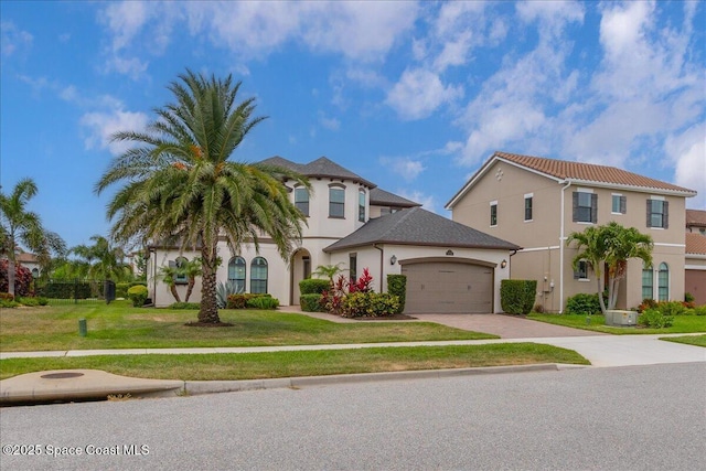 2228 Zuma Ln, Melbourne, FL 32940 - view of front of house with driveway, stucco siding, an attached garage, and a front yard