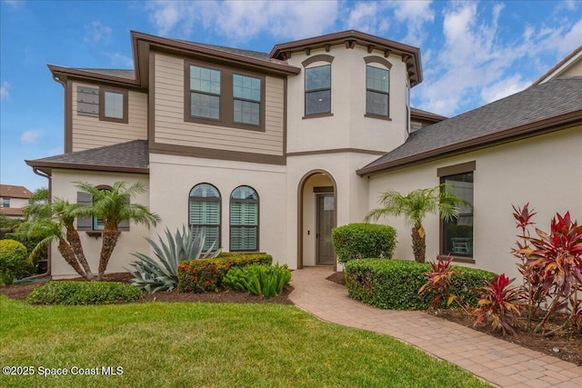 2228 Zuma Ln, Melbourne, FL 32940 - view of front facade with a front lawn, stucco siding, and a shingled roof