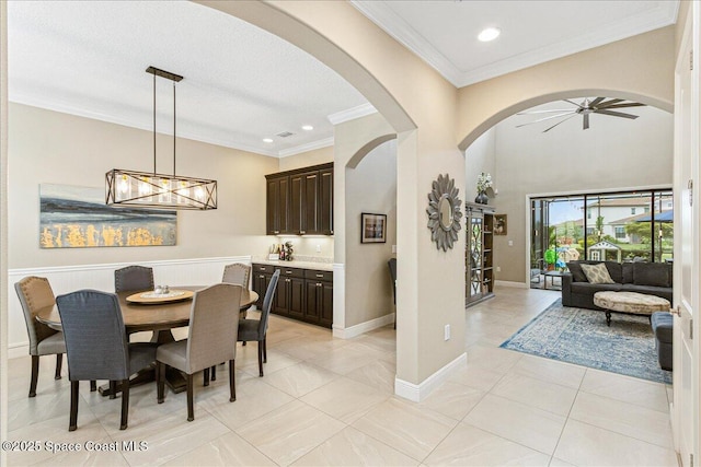 2228 Zuma Ln, Melbourne, FL 32940 - dining area with ceiling fan, arched walkways, ornamental molding, recessed lighting, and light tile patterned floors
