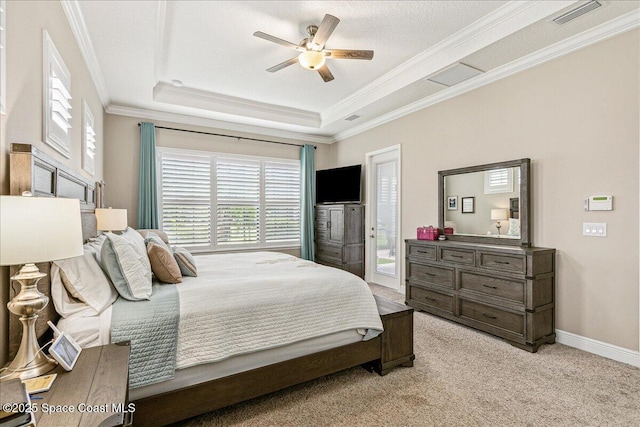 2228 Zuma Ln, Melbourne, FL 32940 - bedroom featuring a tray ceiling, multiple windows, ornamental molding, light carpet, and a ceiling fan
