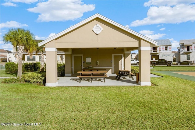 2228 Zuma Ln, Melbourne, FL 32940 - rear view of house featuring a lawn, stucco siding, and a patio