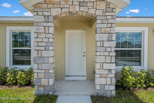 1650 Wyoming Dr SE, Palm Bay, FL 32909 - view of exterior entry featuring stone siding and stucco siding