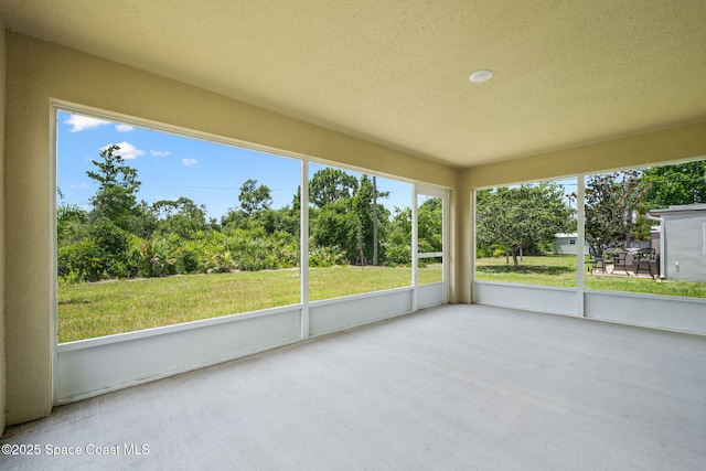 1650 Wyoming Dr SE, Palm Bay, FL 32909 - unfurnished sunroom with view of wooded area