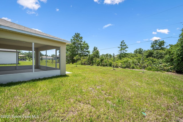 1650 Wyoming Dr SE, Palm Bay, FL 32909 - view of green lawn featuring a sunroom