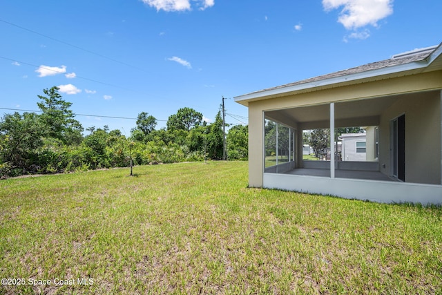 1650 Wyoming Dr SE, Palm Bay, FL 32909 - view of grassy yard with a sunroom