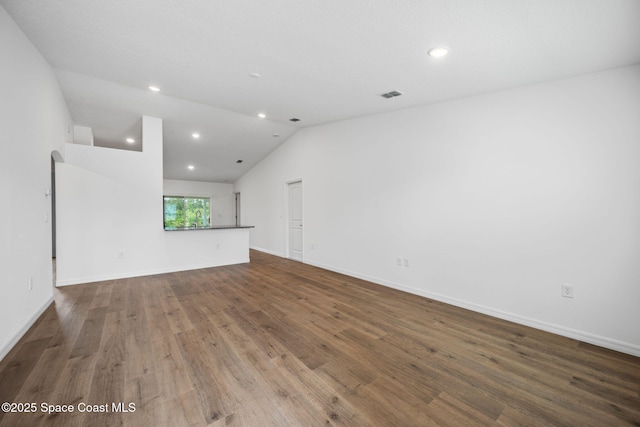 1650 Wyoming Dr SE, Palm Bay, FL 32909 - spare room with recessed lighting, vaulted ceiling, wood finished floors, and baseboards