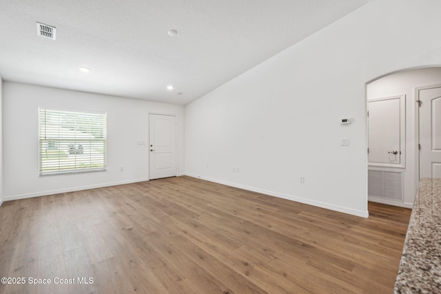 1650 Wyoming Dr SE, Palm Bay, FL 32909 - spare room featuring light wood-type flooring, baseboards, recessed lighting, and arched walkways
