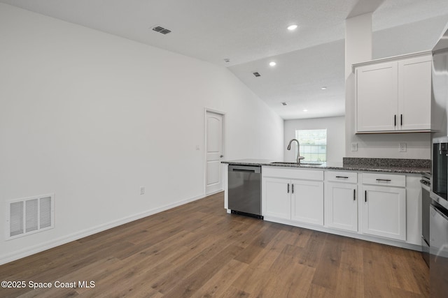 1650 Wyoming Dr SE, Palm Bay, FL 32909 - kitchen featuring dishwasher, a sink, dark wood-type flooring, a peninsula, and white cabinets