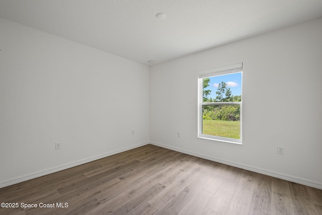 1650 Wyoming Dr SE, Palm Bay, FL 32909 - spare room featuring wood finished floors and baseboards