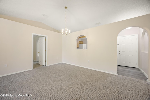 2268 Spring Creek Cir, Palm Bay, FL 32905 - carpeted empty room featuring a chandelier, baseboards, arched walkways, and vaulted ceiling