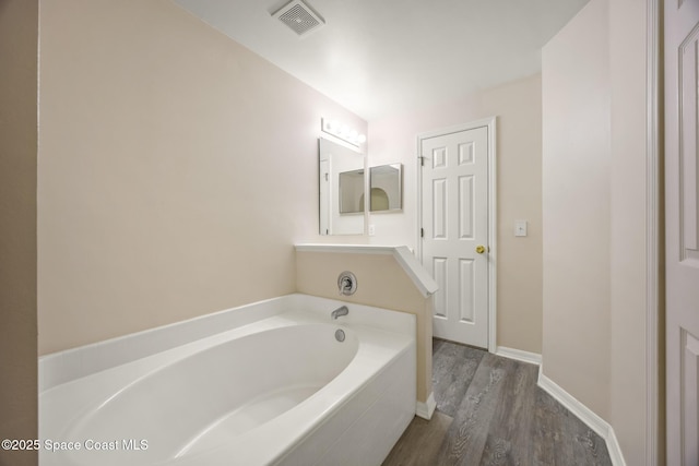 2268 Spring Creek Cir, Palm Bay, FL 32905 - full bathroom with a bath, wood finished floors, and baseboards